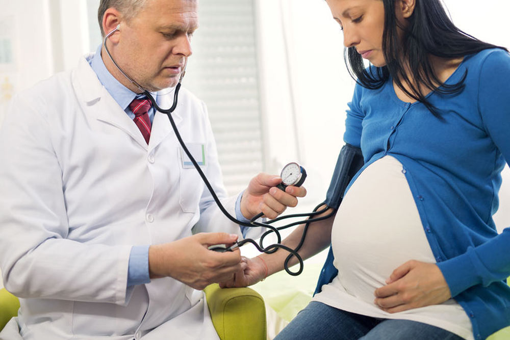 doctor examines pregnant woman