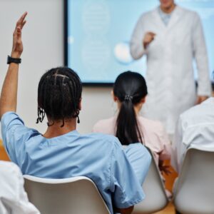 Participant in an active assailant training course raising their hand to ask a question.