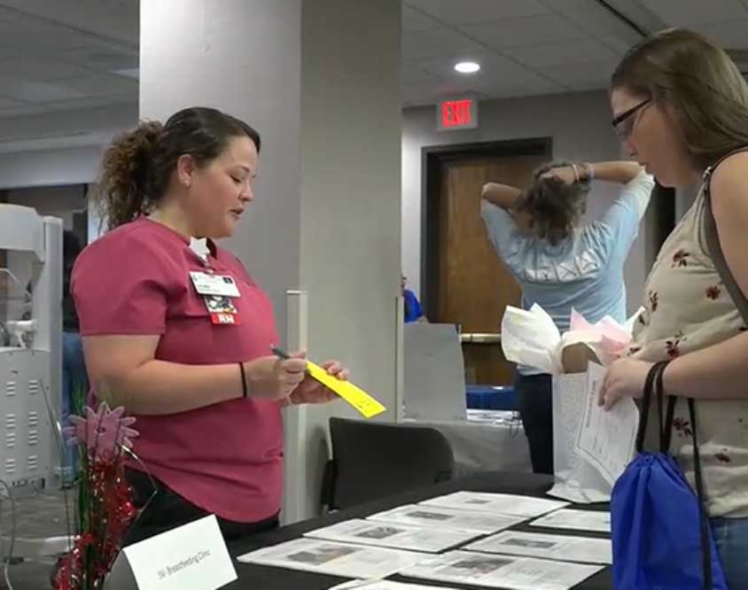 Laura Odom, Registered Nurse and International Board Certified Lactation Consultant (RN, IBCLC), from the Stormont Vail Health Breastfeeding Clinic talks to a mom at Welcome Baby Jubilee