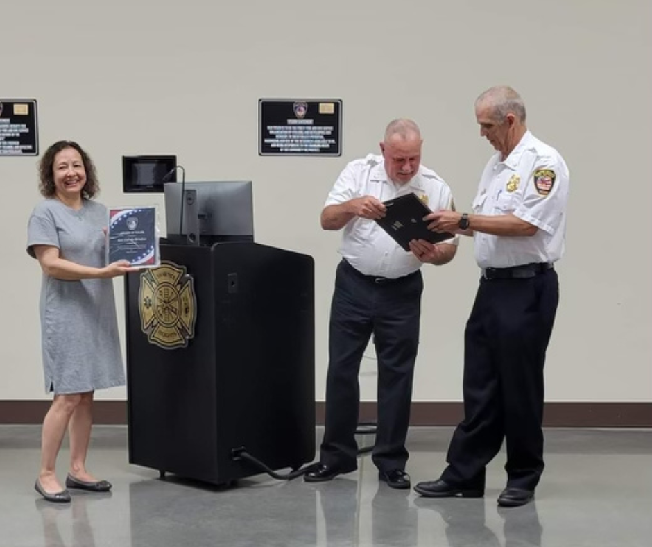 The Fire District presenting a woman with an award