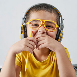 young boy in glasses with headphones on