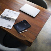 Newspaper on a table with a digital tablet